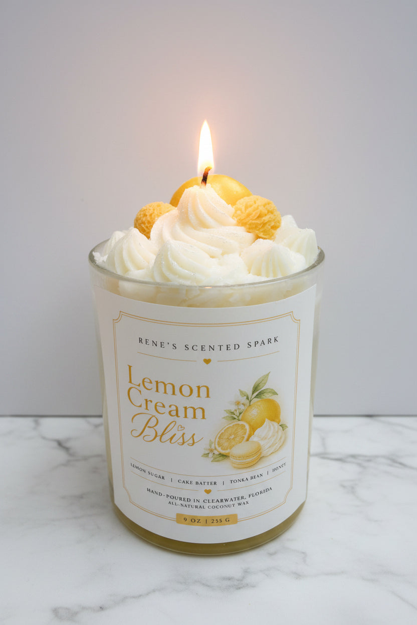 Candle in a glass jar labeled 'Lemon Cream Bliss' with decorative elements on top.