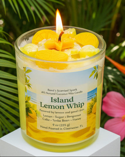 Candle labeled 'Island Lemon Whip' with a lit wick and floating lemon slices against a green leafy background.
