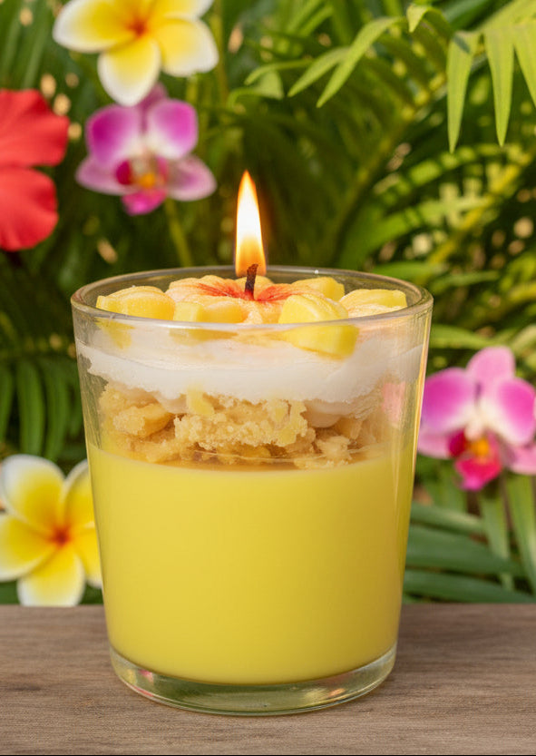lemon scented candle with a flower mold and small yellow lemons wit a tropical label with lemons.