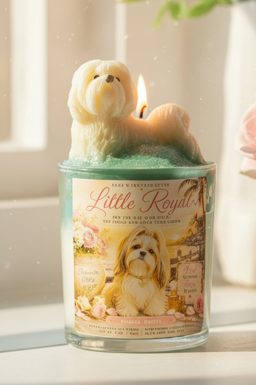Candle shaped like a dog with a 'Little Royals' label on a windowsill.