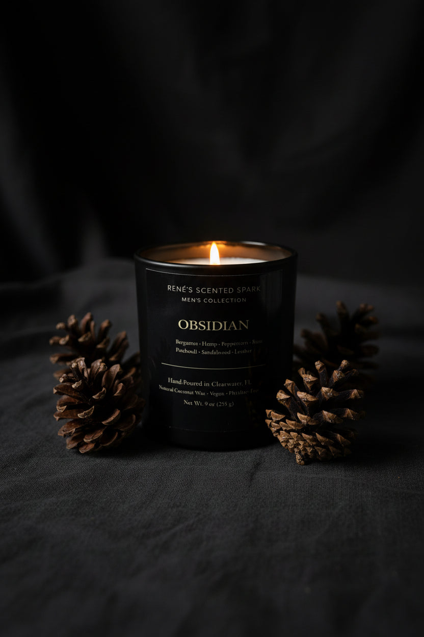 Obsidian scented candle with pinecones on a dark background