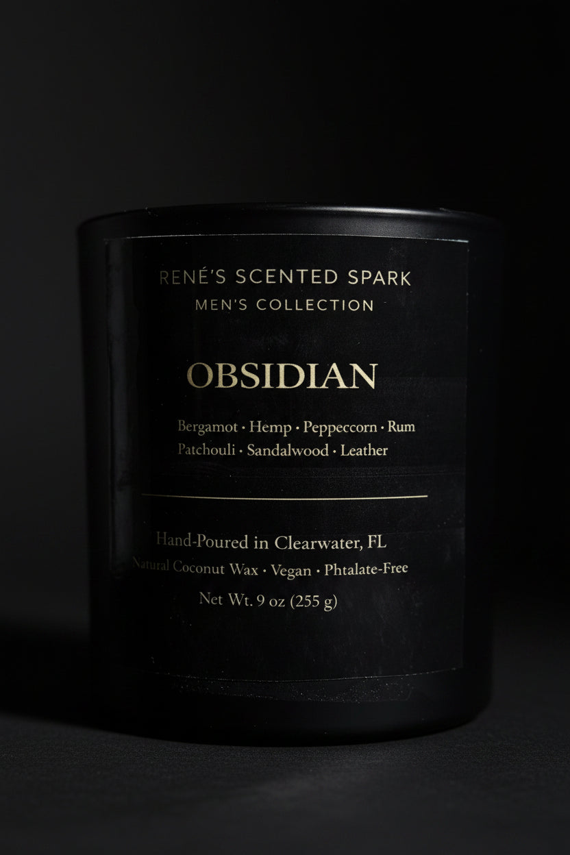 Black candle labeled 'Obsidian' from Rene's Scented Spark Men's Collection on a dark background