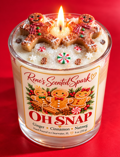 Lit Oh Snap gingerbread Christmas candle with two hand-sculpted gingerbread man toppers and peppermint candies on a red background