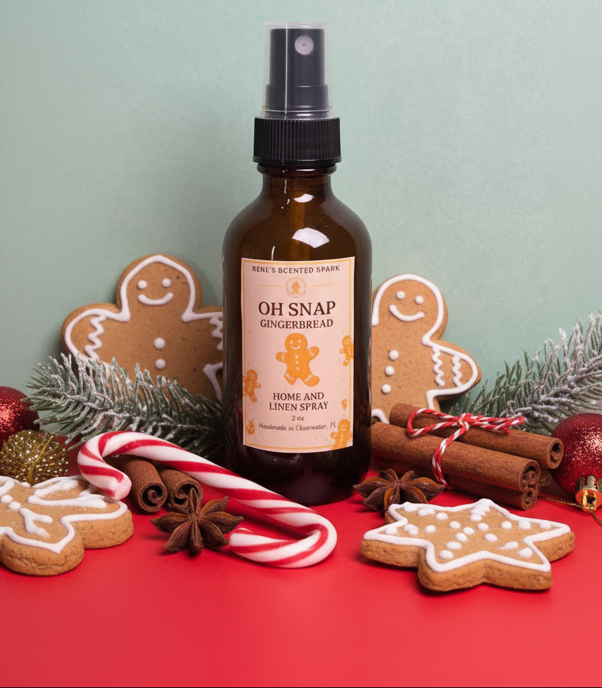 Brown spray bottle labeled 'Oh Snap Gingerbread' with gingerbread cookies, candy canes, and cinnamon sticks on a red surface.