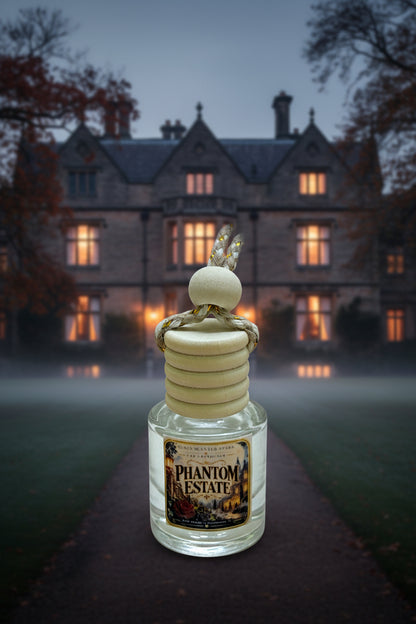 Phantom Estate hanging car freshener displayed in front of a misty old manor at dusk with glowing windows and dark autumn trees.