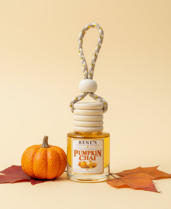 Pumpkin Chai hanging car freshener displayed with a mini orange pumpkin and autumn leaves on a warm cream background. 🎃🍂