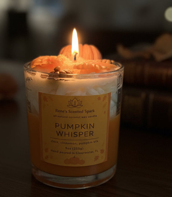 Pumpkin-themed candle with decorative elements on a white block against a purple background