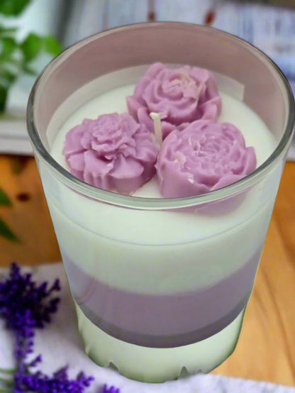 Lovely Lavender candle glowing on a table beside books and flowers, creating a spa-like, calming atmosphere — perfect for self-care or gifting