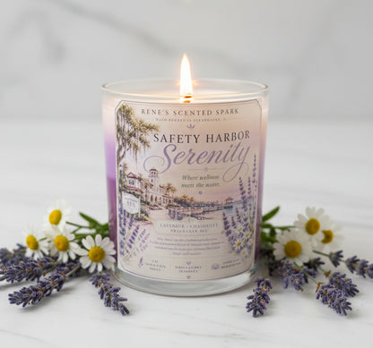 Safety Harbor Serenity lavender chamomile candle glowing surrounded by fresh lavender and white chamomile flowers on a soft white surface