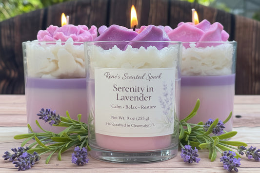 Lavender candle with whipped wax topping and layered coconut wax, lit in glass jar with fresh lavender sprigs