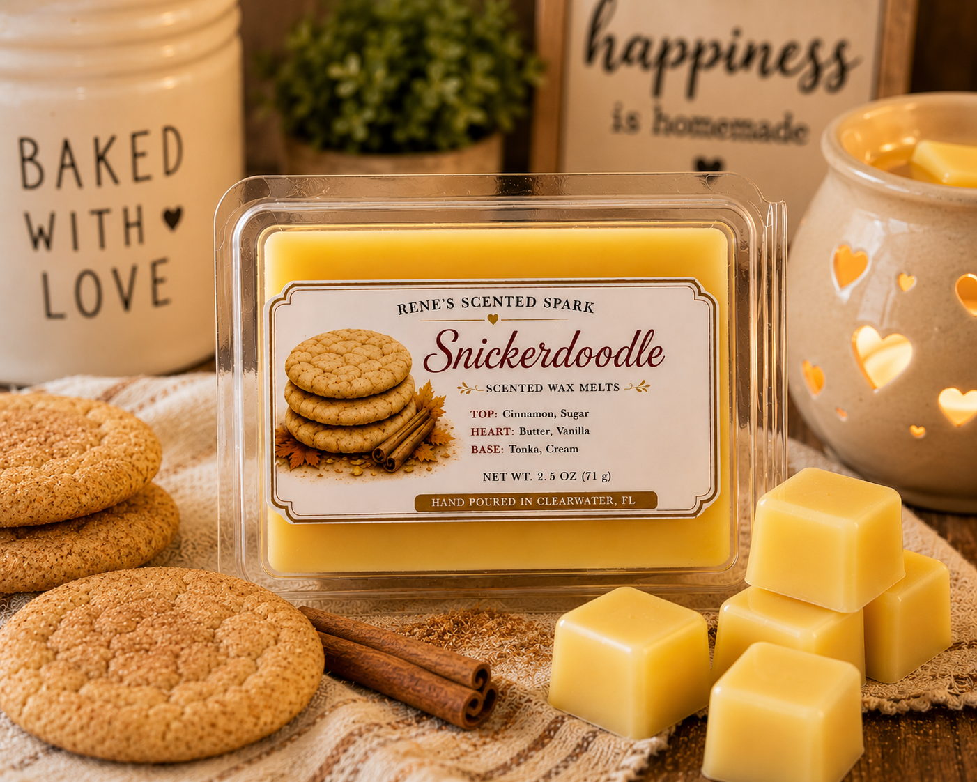 Snickerdoodle scented wax melts by Renes Scented Spark styled with cinnamon sugar cookies, cinnamon sticks, golden wax cubes and a glowing wax warmer in a cozy kitchen setting.