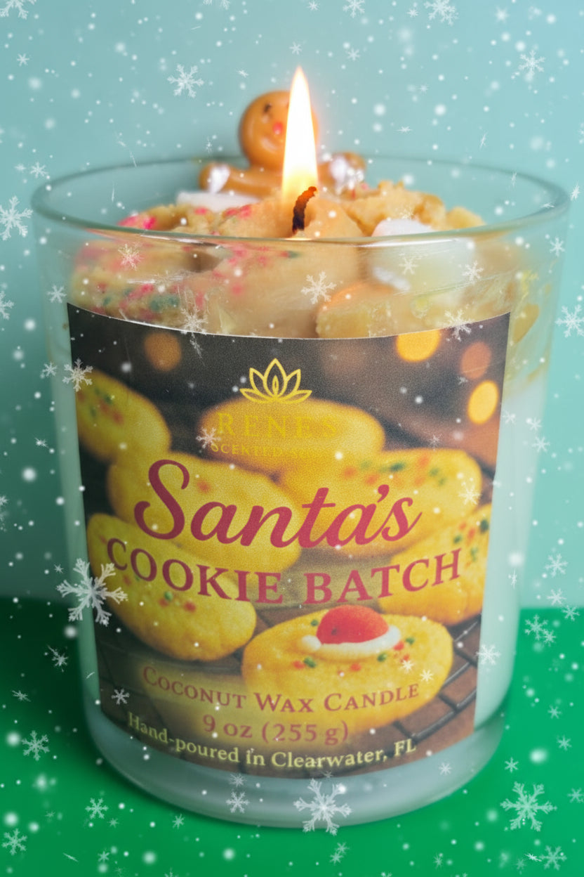 Candle labeled 'Santa's Cookie Batch' with a gingerbread man on top, against a festive background.