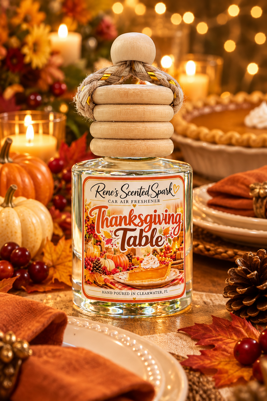 Thanksgiving car freshener on an elegant Thanksgiving dinner table with warm amber candlelight, cream plates, burnt-orange linen napkins, small pumpkins, autumn leaves, pinecones, cranberries, and soft golden string lights in the background.