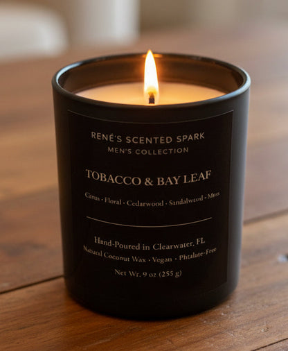 Candle with 'Tobacco & Bay Leaf' fragrance on a wooden surface