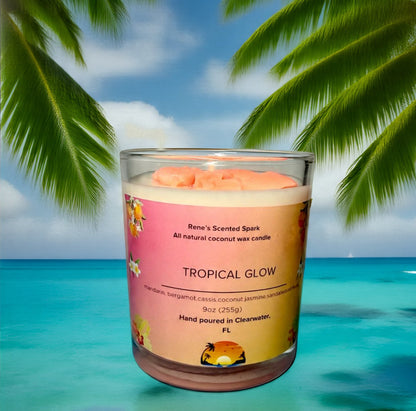 Tropical Glow coconut wax candle by Rene’s Scented Spark with a coral-colored wax top, in a glass jar with tropical floral label. Hand-poured in Clearwater, FL. Scented with mandarin, cassis, coconut, jasmine, sandalwood, and musk. Gift-ready tropical candle