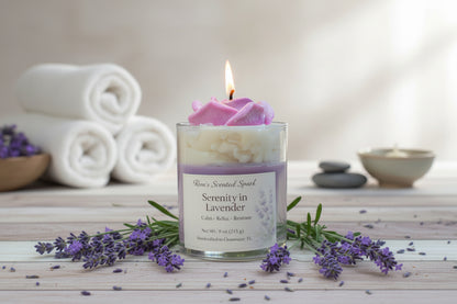 Serenity in Lavender coconut wax candle with rose wax top, lavender sprigs, and spa towels in relaxing setting