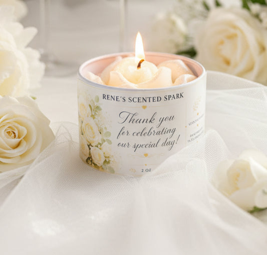 4 oz wedding favor candle with white rose wax topper and personalized thank-you label, styled with ivory roses and soft white fabric.