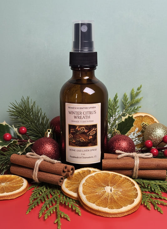 Bottle of winter citrus wreath spray with Christmas decorations in the background