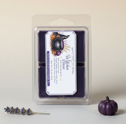 Witches Brew purple wax melts by Rene’s Scented Spark displayed on a light neutral background with a small purple pumpkin and lavender sprig.