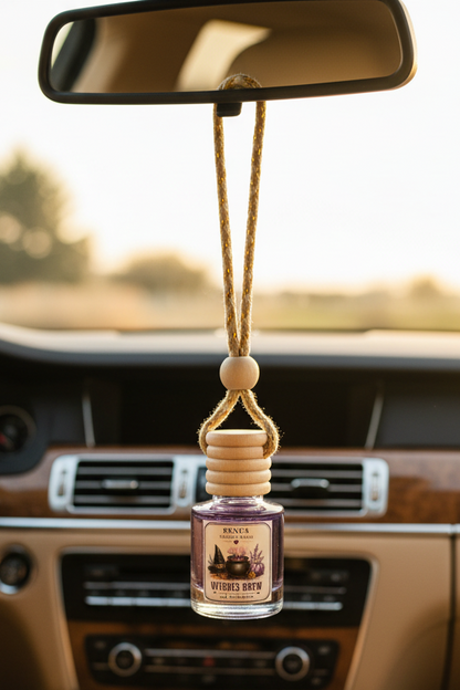 witches brew car freshener hanging from a rearview mirror in a nice car interior.